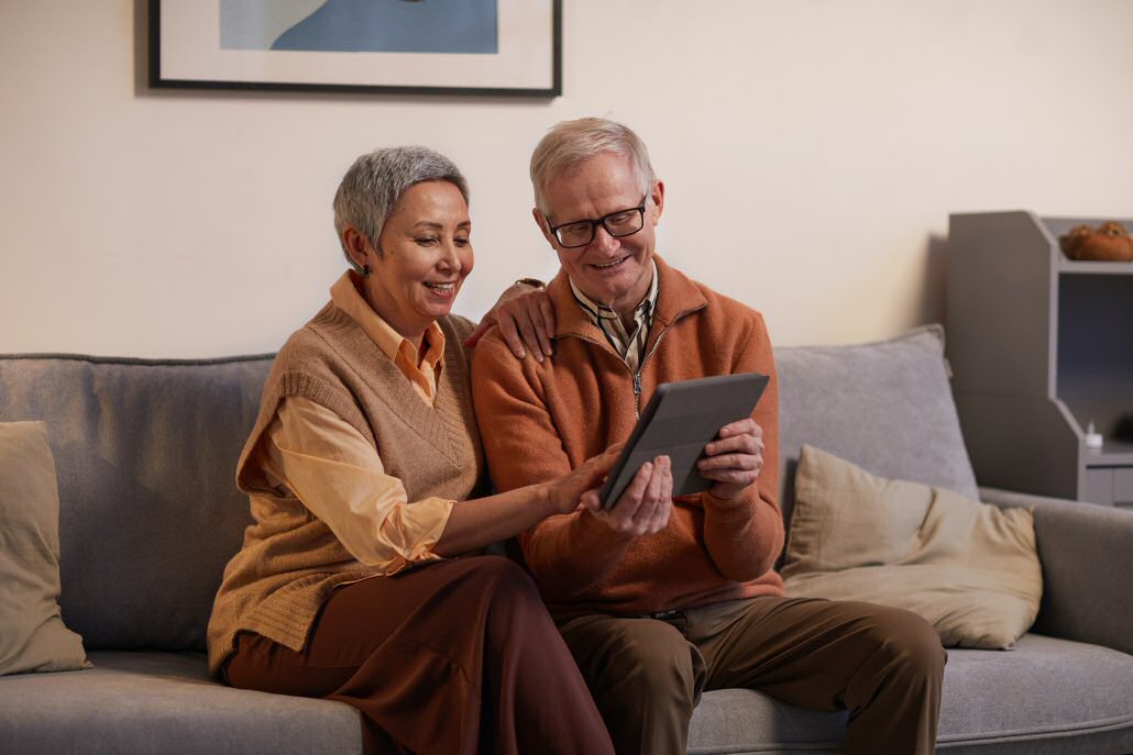 grandparents on couch with iPad