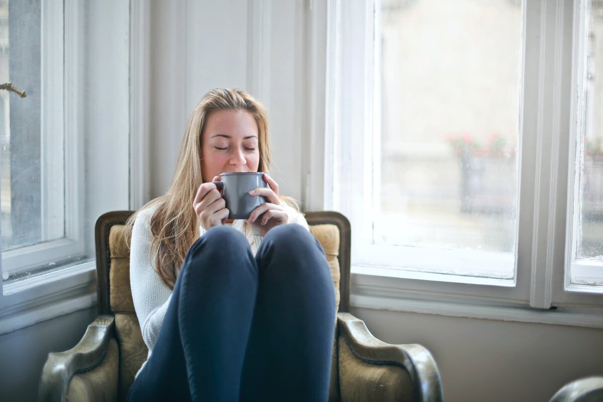 woman with coffee on chair