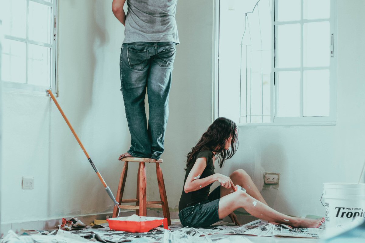 man and woman painting room